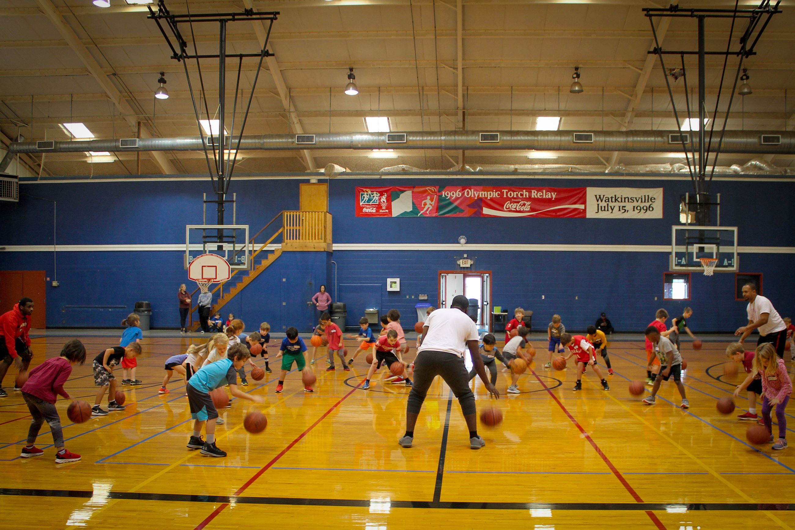 Children dribbling basketballs