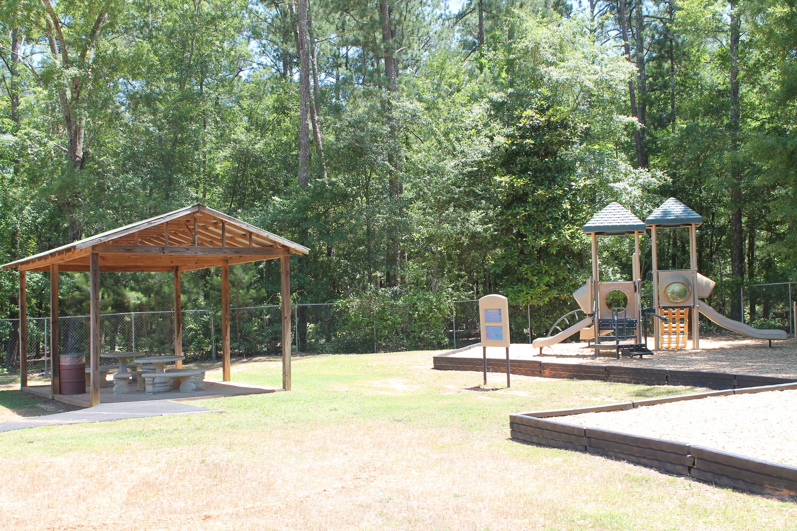 Small Pavilion with two tables and play structure located at Bogart Sports Complex